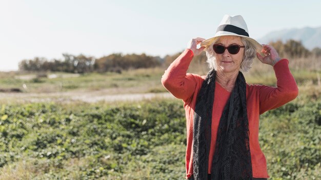 Medium shot woman wearing a hat