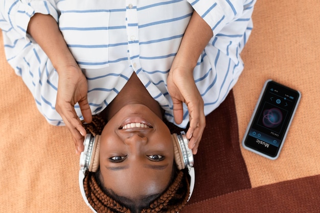 Medium shot woman wearing headphones flat lay