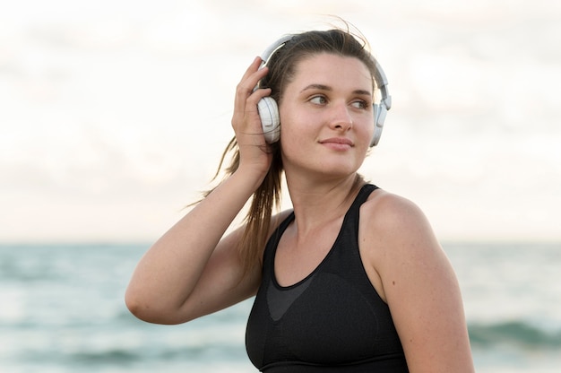 Medium shot woman wearing headphones