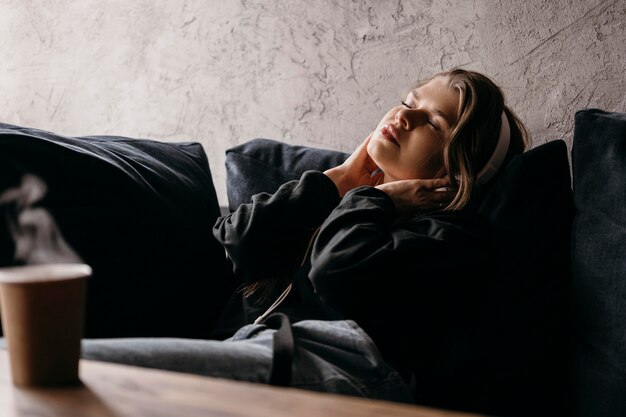 Medium shot woman wearing headphones