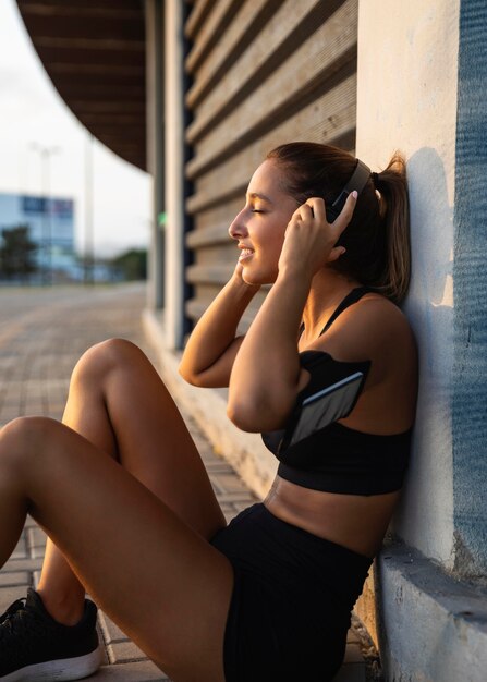 Medium shot woman wearing headphones