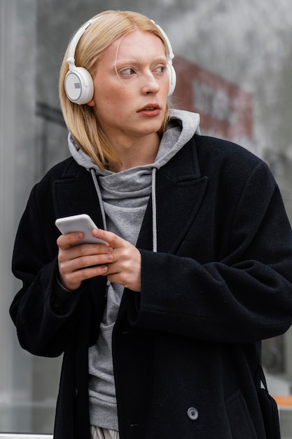 Medium shot woman  wearing headphones