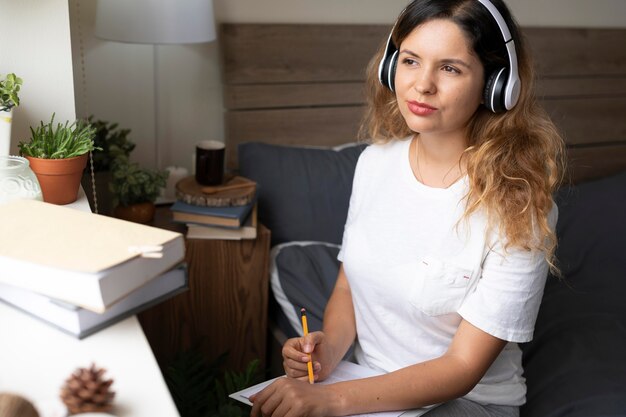 Medium shot woman wearing headphones