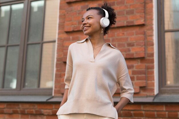 Medium shot woman wearing headphones