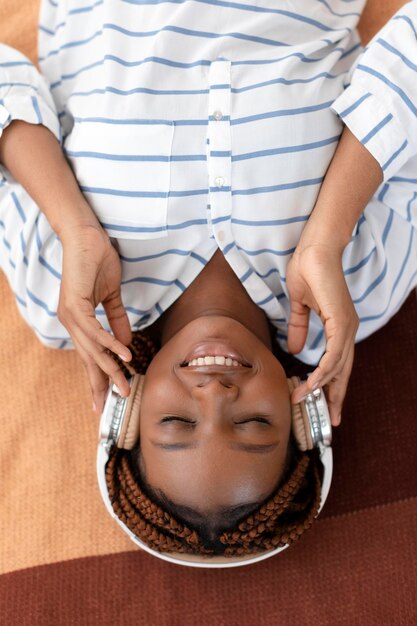 Medium shot woman wearing headphones