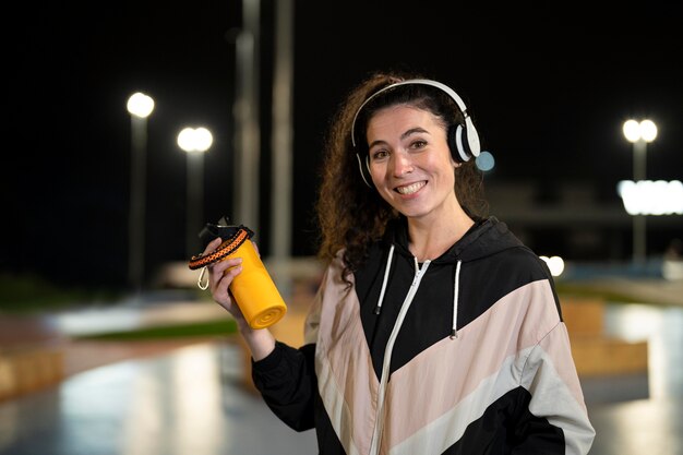 Medium shot woman wearing headphones