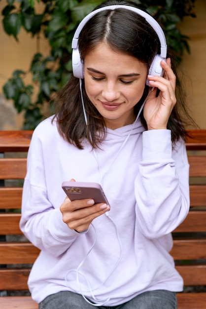 Free photo medium shot woman wearing headphones