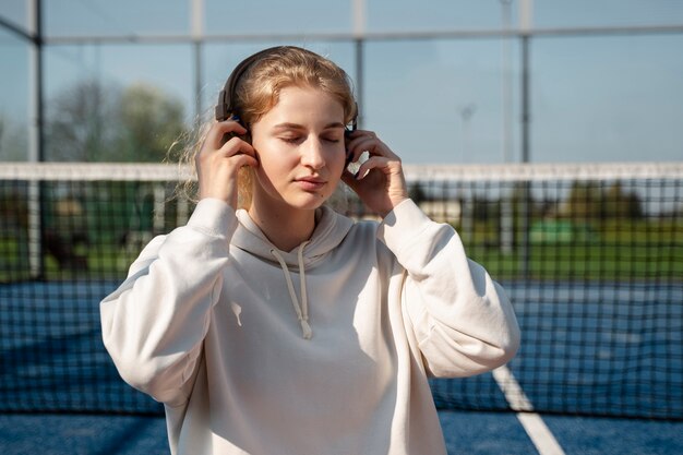 Free photo medium shot woman wearing headphones