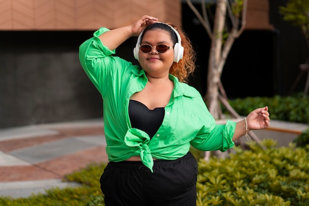 Medium shot woman wearing headphones