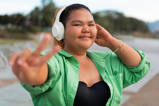 Medium shot woman wearing headphones