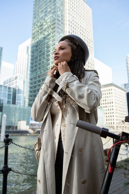 Medium shot woman wearing helmet in city