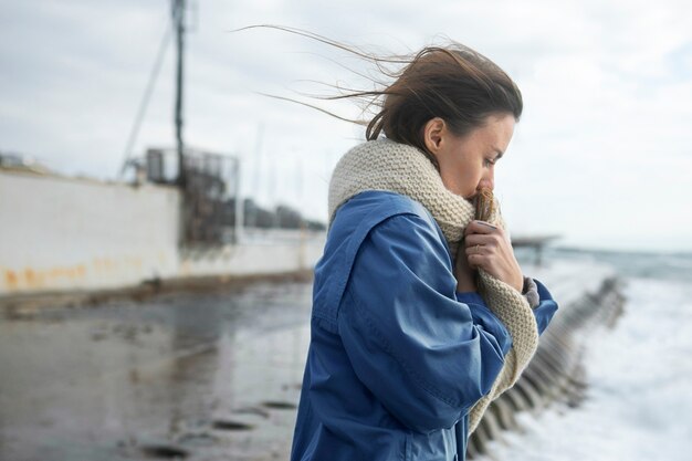 Medium shot woman wearing knitted scarf