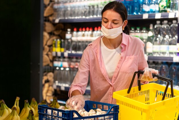 Medium shot woman wearing mask in shop