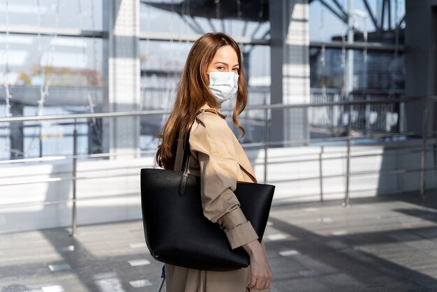 Medium shot woman wearing mask