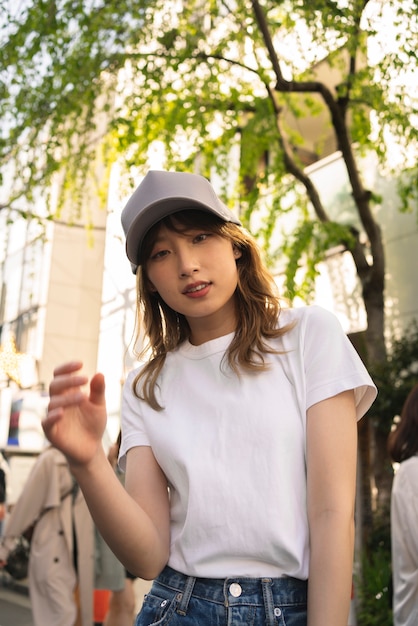 Medium shot woman wearing trucker hat outside