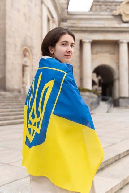 Medium shot woman wearing ukrainian flag