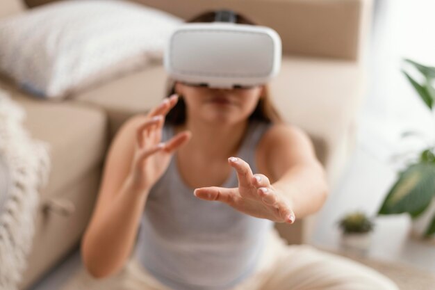 Medium shot woman wearing vr glasses