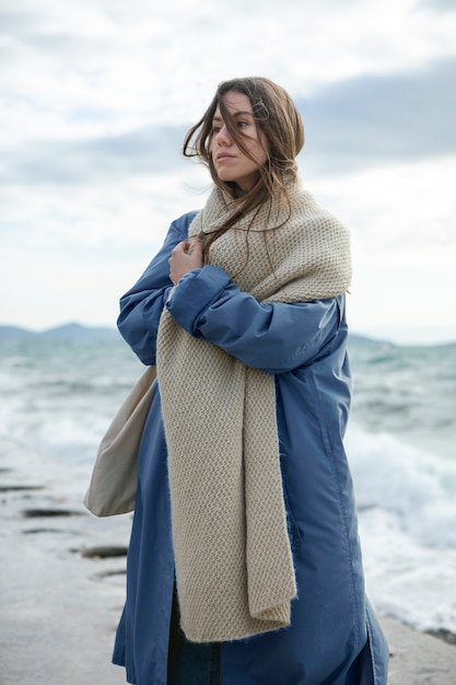 Medium shot woman wearing warm scarf