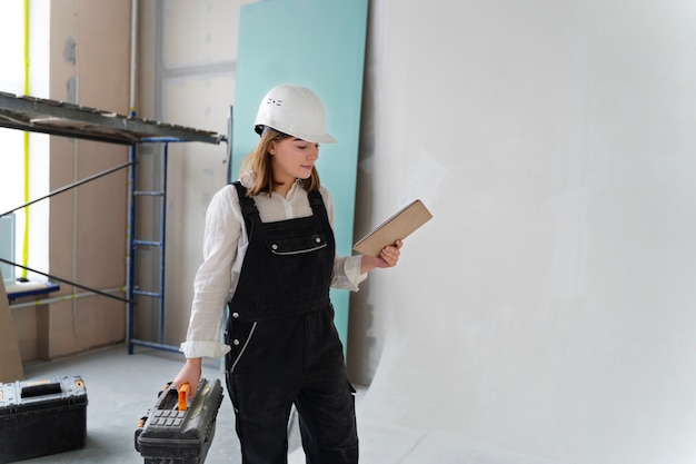 Donna del colpo medio che indossa il casco bianco