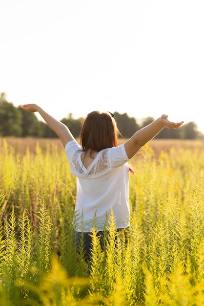 Medium shot of a woman with arms in the air