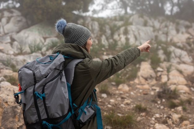 Free photo medium shot woman with backpack in nature