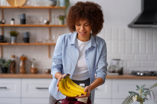 medium shot woman with bananas