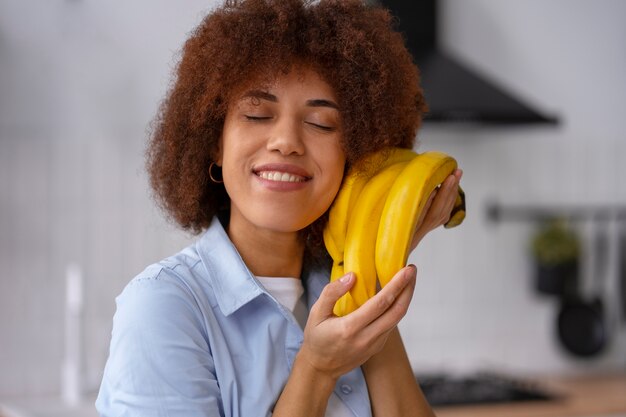 Medium shot woman with bananas