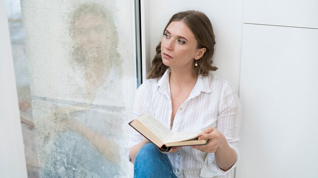 Medium shot woman with book