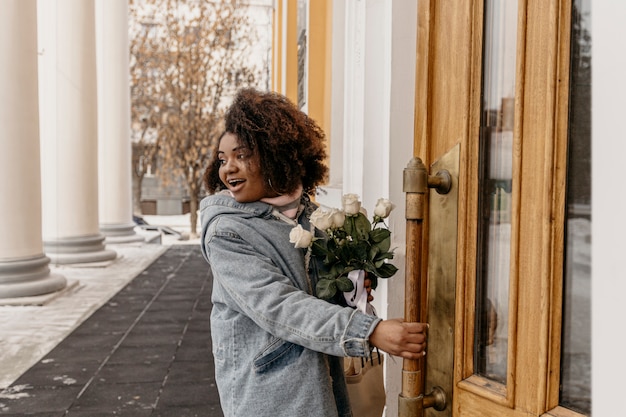 Medium shot woman with bouquet