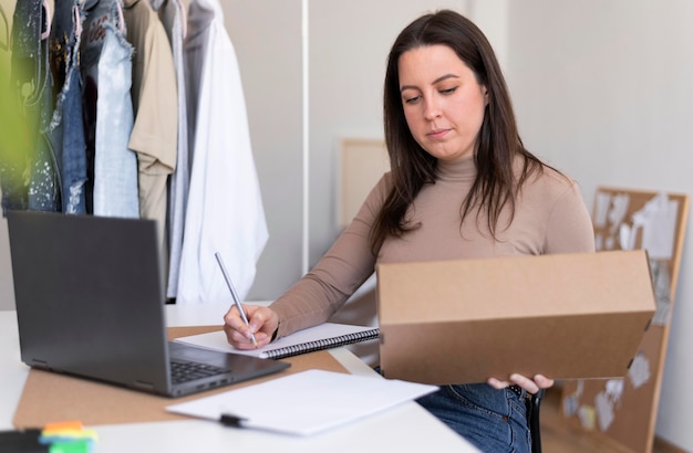 Free photo medium shot woman with box