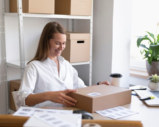 Medium shot woman with box