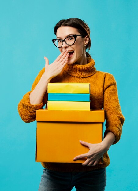 Medium shot of woman with boxes