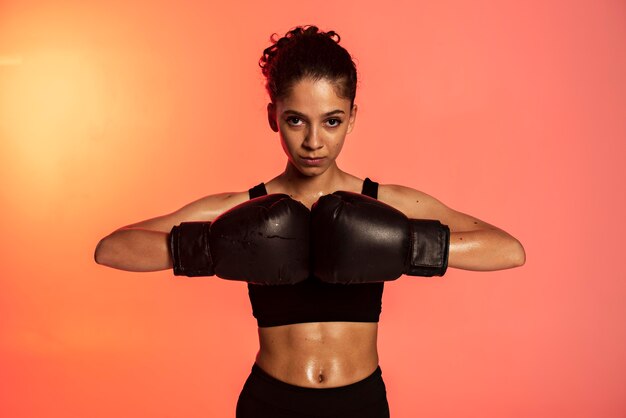 Medium shot woman with boxing gloves