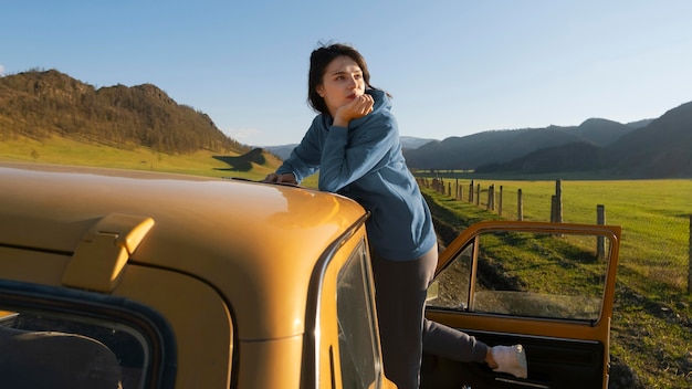 Medium shot woman with car