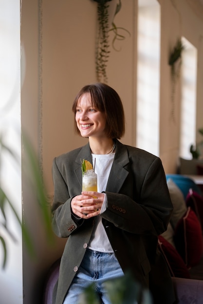 Medium shot woman with delicious cocktail