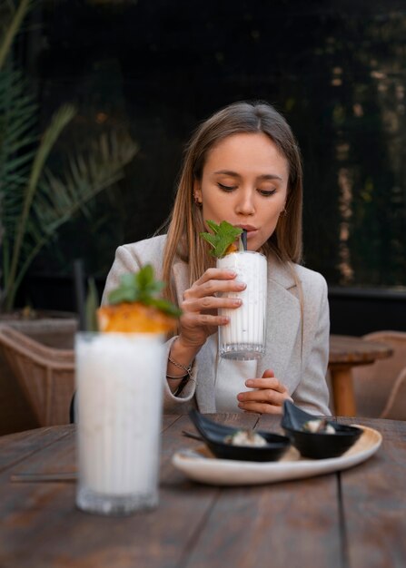 Medium shot woman with delicious pina colada