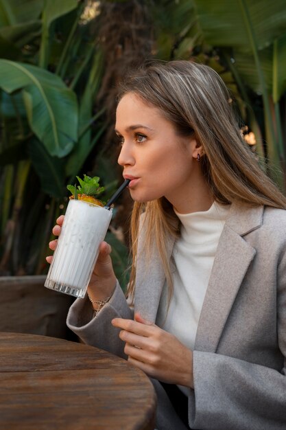 Medium shot woman with delicious pina colada