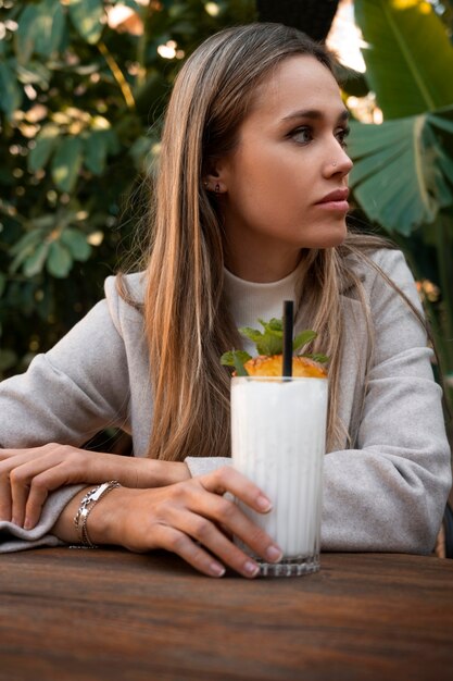 Medium shot woman with delicious pina colada