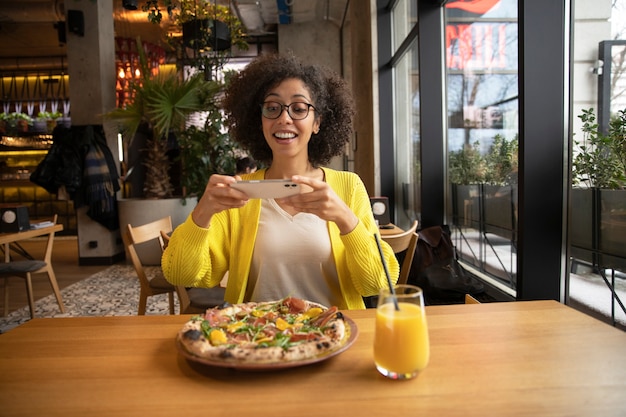 medium shot woman with delicious pizza