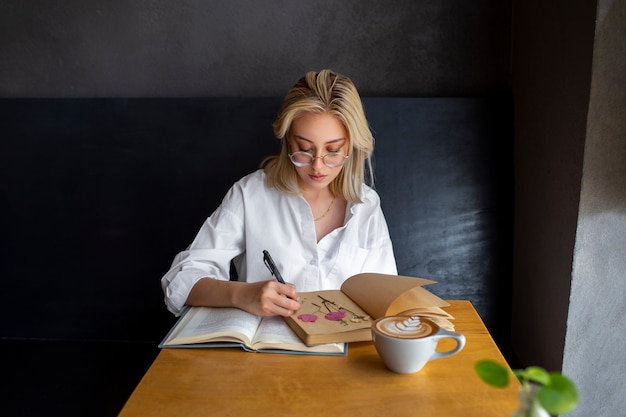 Free photo medium shot woman with diary and book