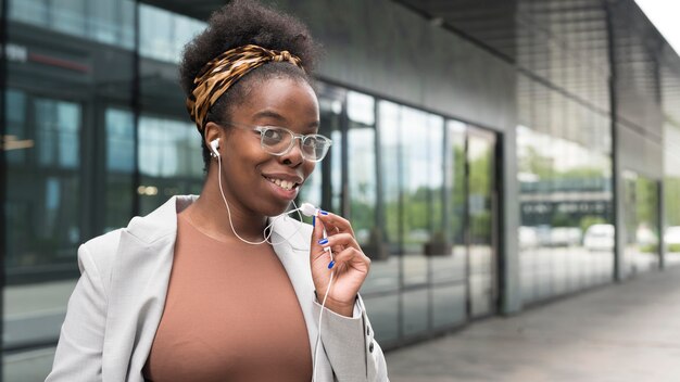 Medium shot woman with earphones