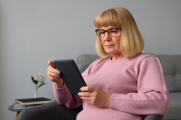 Medium shot  woman with ebook reader