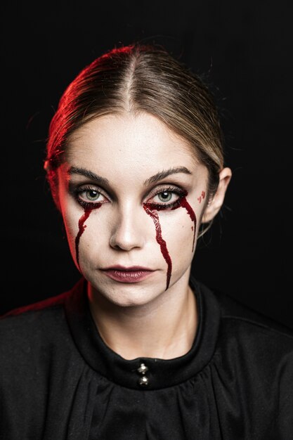 Medium shot of woman with fake blood make-up