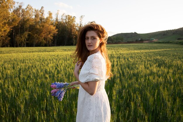 Medium shot woman with flowers bouquet