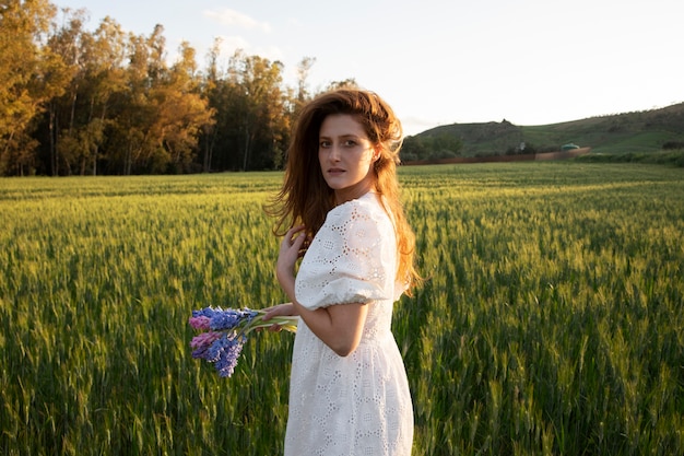 Medium shot woman with flowers bouquet