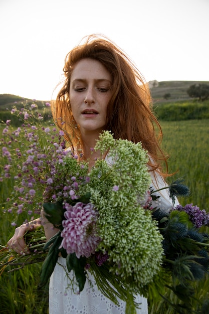 Medium shot woman with flowers bouquet