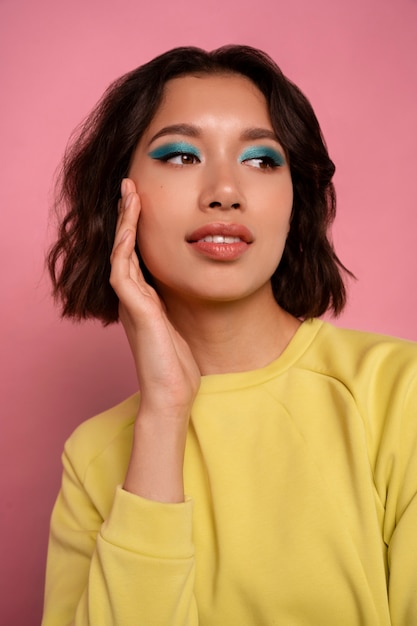 Medium shot woman with graphic eye makeup