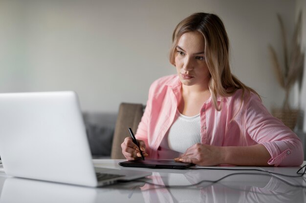 Medium shot woman with graphic tablet