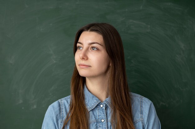 Medium shot woman with green board