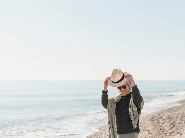 Medium shot woman with hat in nature